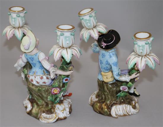 A pair of Meissen figural candelabra, late 19th century, height 19.5cm, typical minor losses to flowers, replacement nozzles